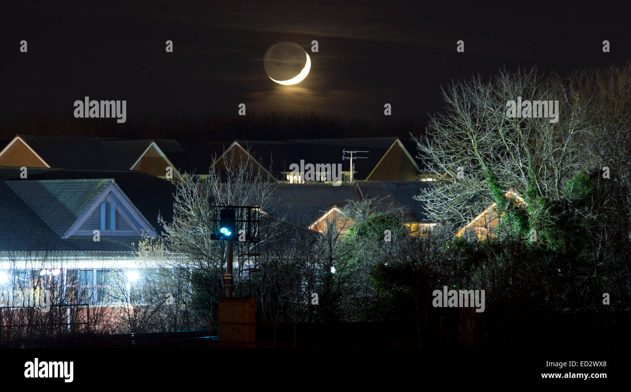 Warwick, Warwickshire, England, UK. 24. Dezember 2014. Der Mond setzt am Heiligen Abend über den Dächern von Warwick. Bildnachweis: Colin Underhill/Alamy Live-Nachrichten Stockfoto