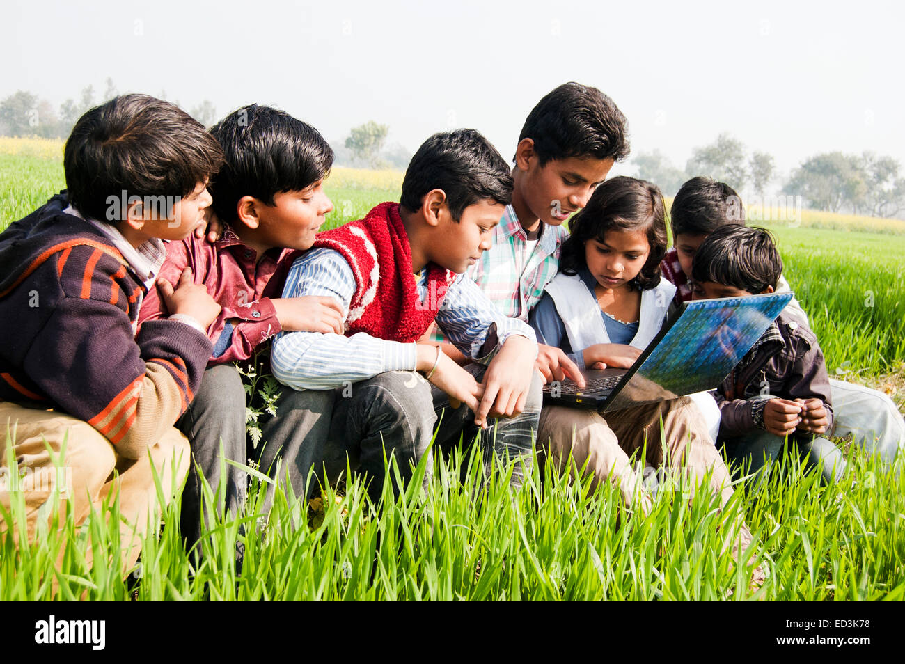 Genießen Sie indische ländlichen Kindergruppe Feld laptop Stockfoto
