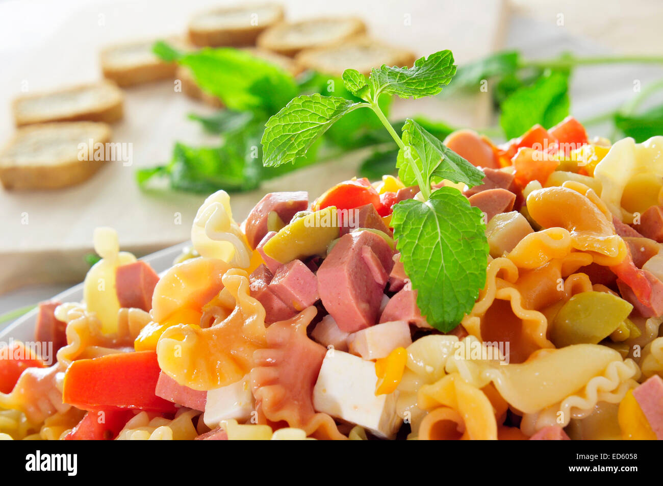 Nahaufnahme von einem erfrischenden Pasta-Salat mit Feta-Käse, Tomaten, Oliven und Frankfurter Würstchen Stockfoto