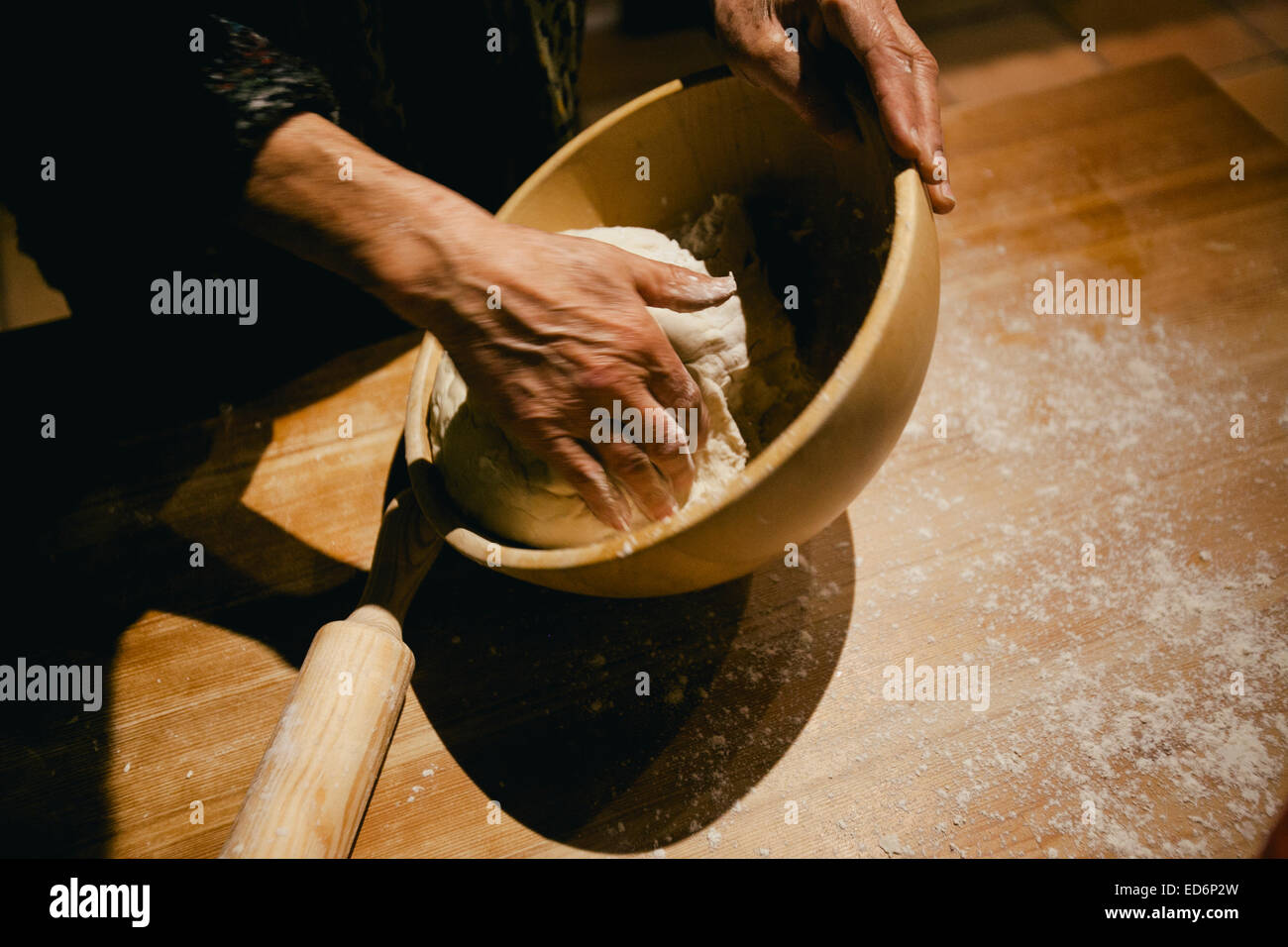 Händen kneten Weizen Brotteig auf einem Holztisch Stockfoto