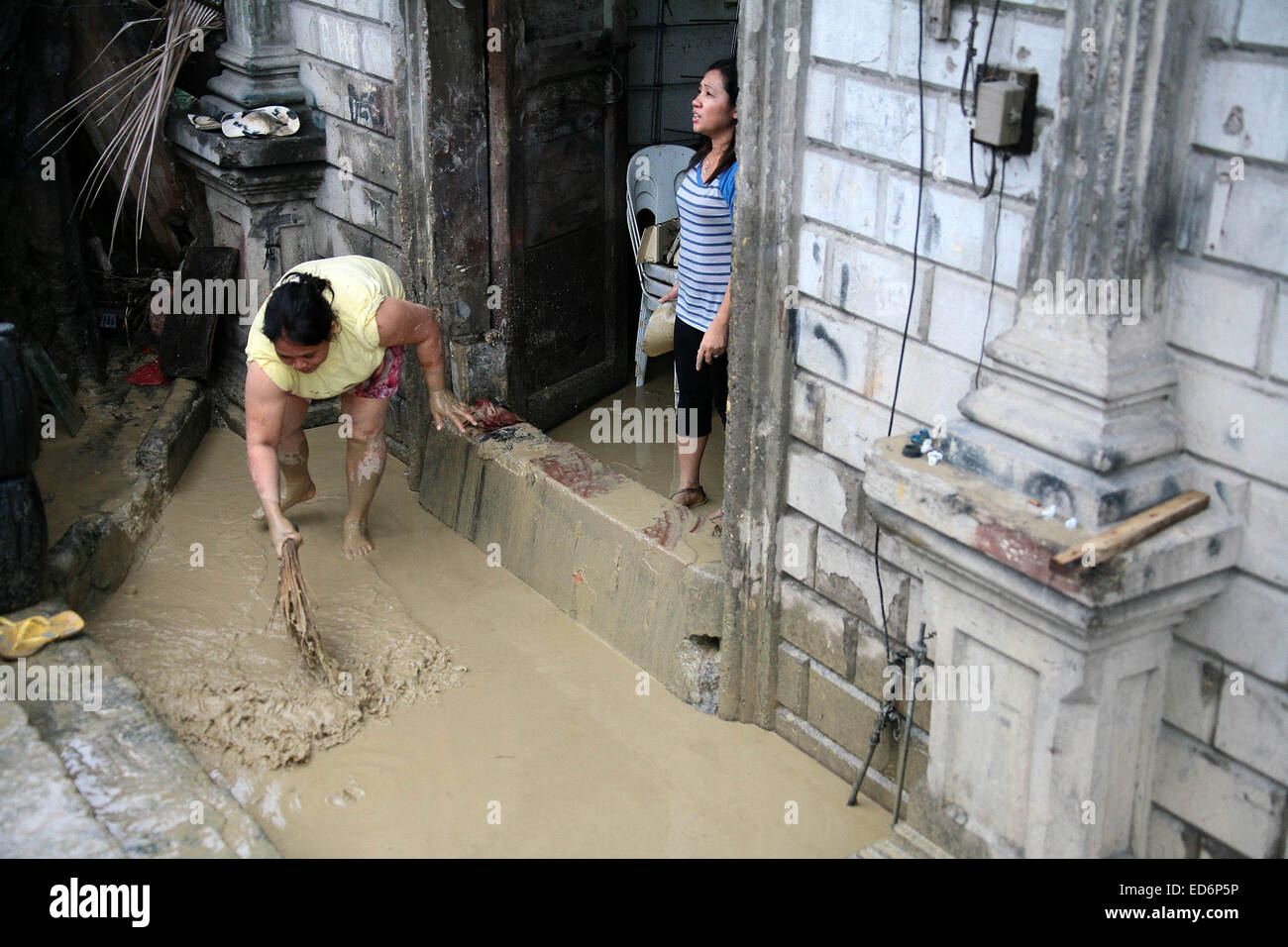 Cebu, Philippinen. 30. Dezember 2014. Bewohner reinigen Sie ihr Haus von Schlamm nach einer Überschwemmung im Provinz Cebu, Philippinen, 30. Dezember 2014 tropischer Sturm Jangmi gebracht. Mindestens sechs Menschen starben in Flut ausgelöst Vorfälle und ein anderer war angeblich fehlende als tropischer Sturm Jangmi (lokaler Name Seniang) zentrale-Philippinen, traf Regierungsquellen, sagte am Dienstag. Bildnachweis: Stringer/Xinhua/Alamy Live-Nachrichten Stockfoto