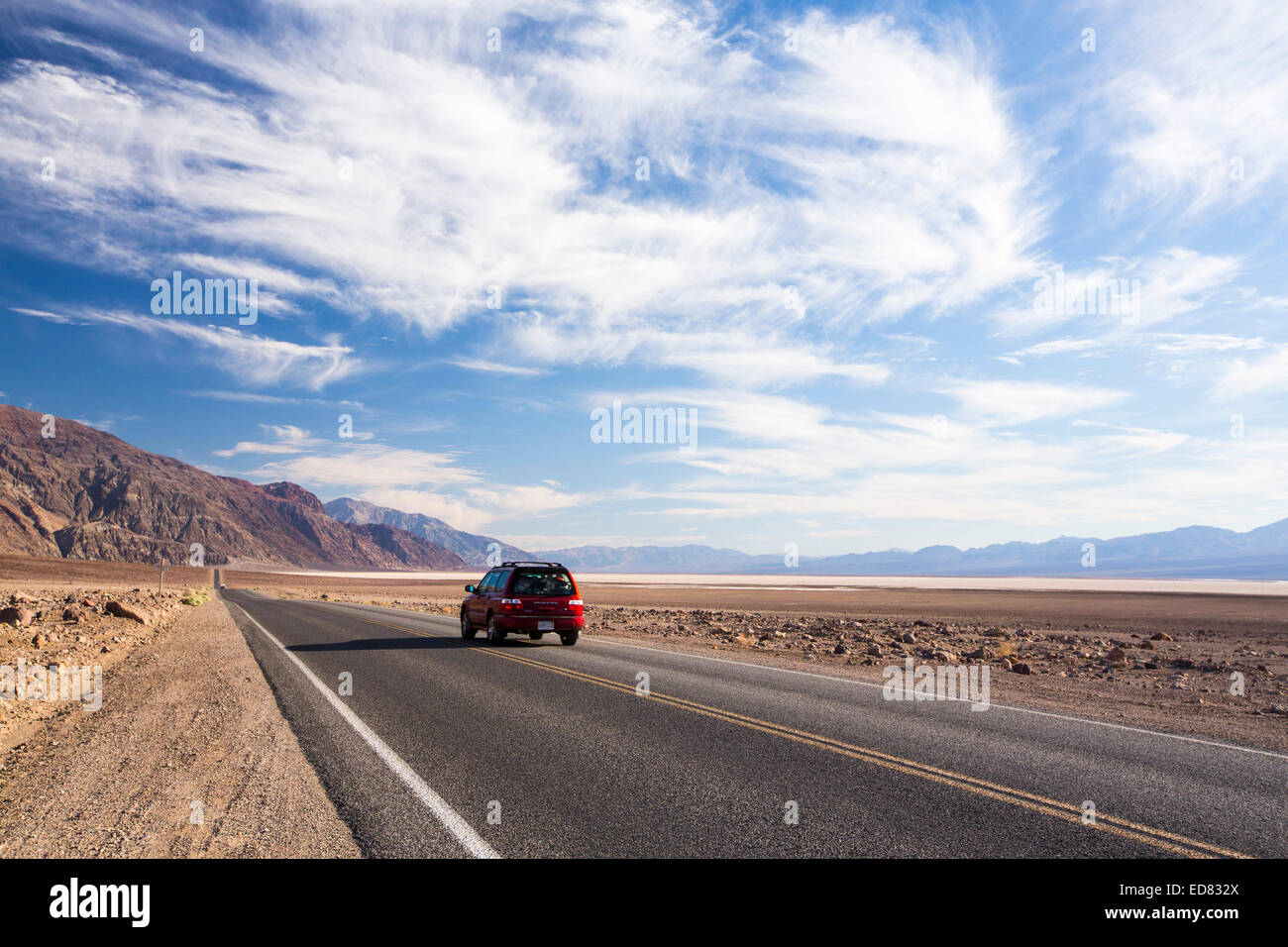 Ein Auto auf der Straße in der Nähe von Badwater ist der tiefste Punkt in den USA als 282 Füße unterhalb des Meeresspiegels im Death Valley. Death Valley ist der niedrigsten, heißesten und trockensten Ort in den USA, mit einer durchschnittlichen jährlichen Niederschlagsmenge von etwa 2 Zoll einige Jahre überhaupt keine Regen empfangen wird. Stockfoto