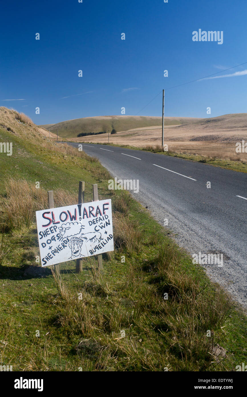 Araf langsam Schäferhunden und Hirten Defaid Cwn ein Bugeiliad humorvollen Cartoon-Stil hand bemalte inoffizielle Straßenschild auf Cwmystwyth Stockfoto