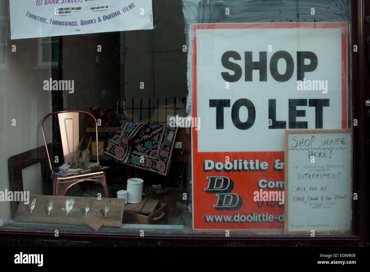 "Shop, lassen" Zeichen in einem leeren oder leer shop Fenster, Bridgnorth, Shropshire UK Stockfoto