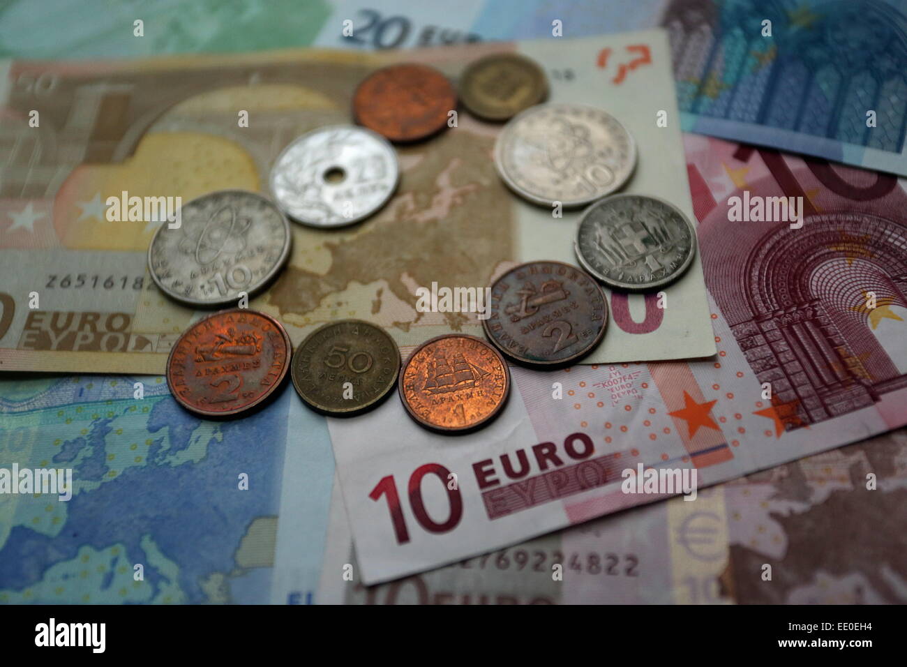Eine Mischung aus alten Drachme Münzen rund um die Karte von Europa auf einen 50 Euro-Papier-Schuldbrief Stockfoto