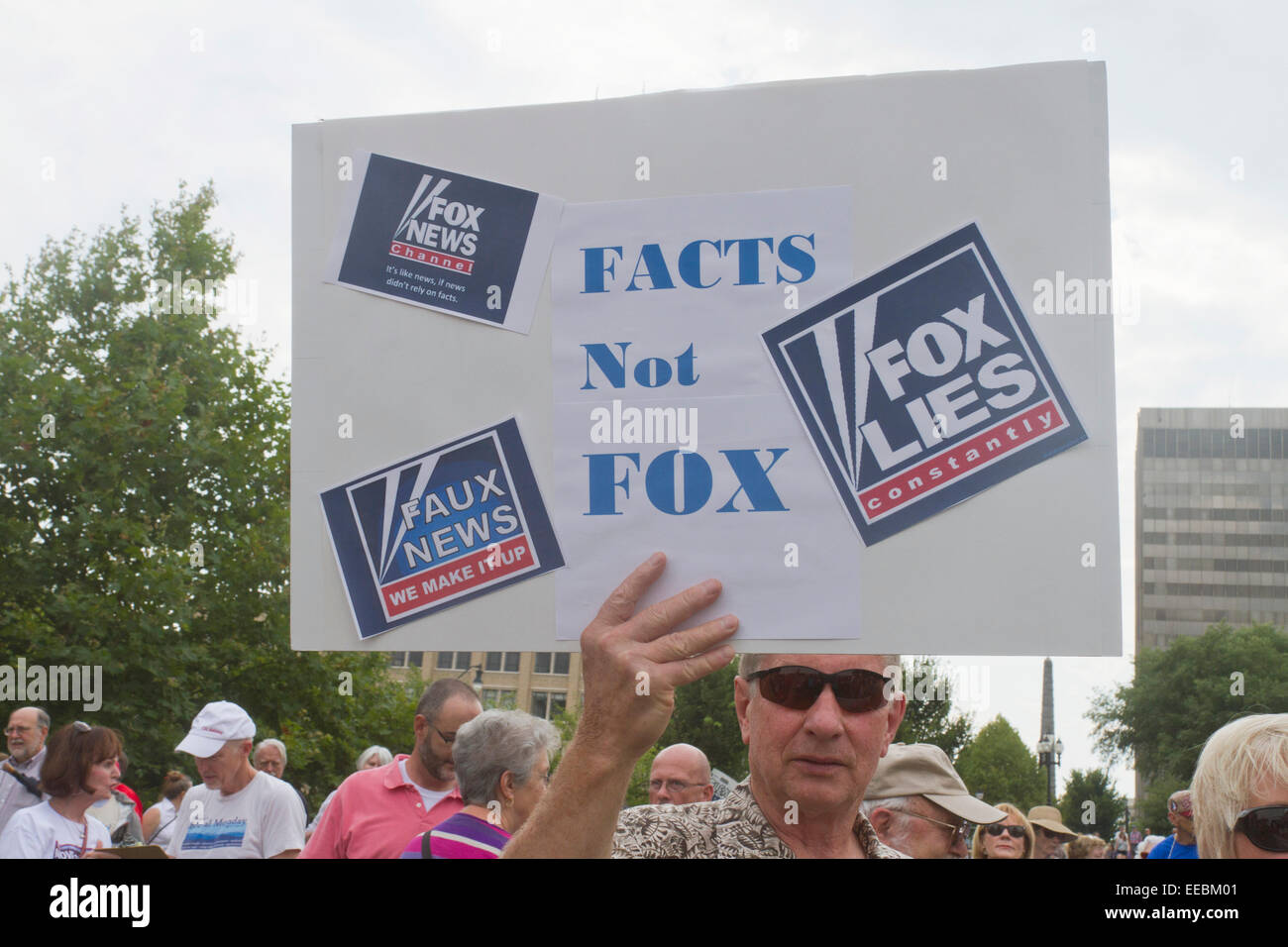 Ein Mann hält ein Schild mit der Aufschrift, dass fox news Lügen und macht die Dinge bis zu einem moralischen Montag Rallye am 4. August 2014 in Asheville, NC Stockfoto
