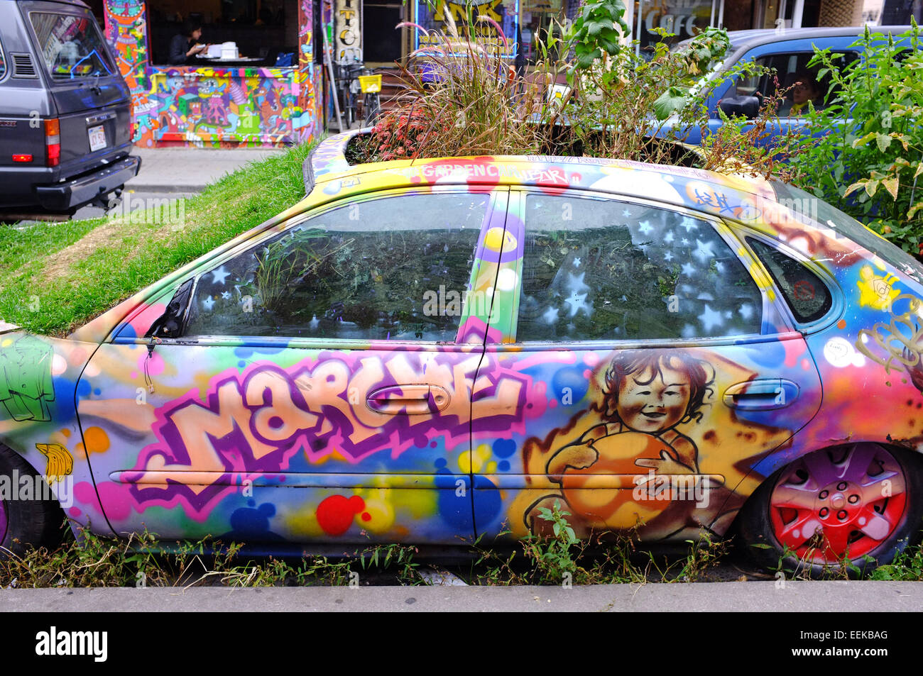 Ein Auto abgedeckt im Graffiti und mit Pflanzen wachsen aus ihm heraus in Toronto, Kanada. Stockfoto