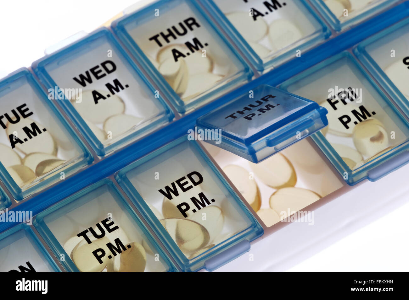 Vitamine im täglichen Pille-Organizer mit einem Slot zu öffnen, auf weißem Hintergrund Stockfoto
