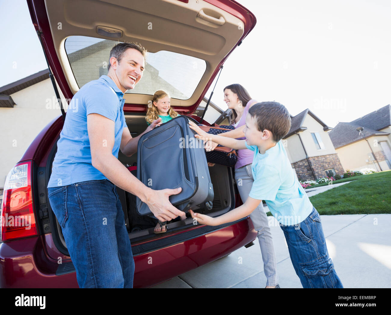 Kaukasische Familie Auspacken Koffer aus dem Auto Stockfoto