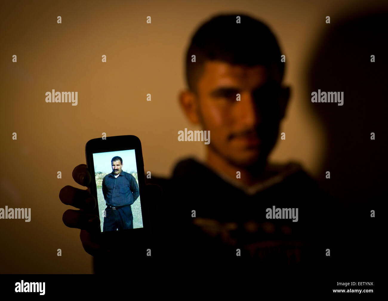 Yezedi Flüchtling aus Sindschar zeigt A Relative getötet durch Daesh auf seinem Handy, Zohar, Kurdistan, Irak Stockfoto