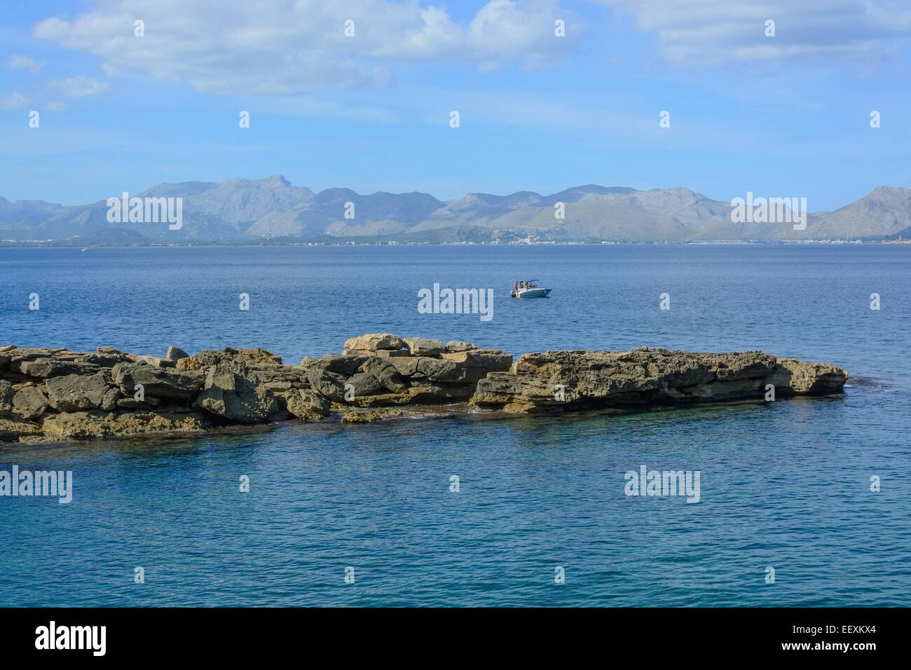 Kleines Motorboot auf Pollensa Bay und Rock Landschaftsraum im Oktober Ruhe. Stockfoto