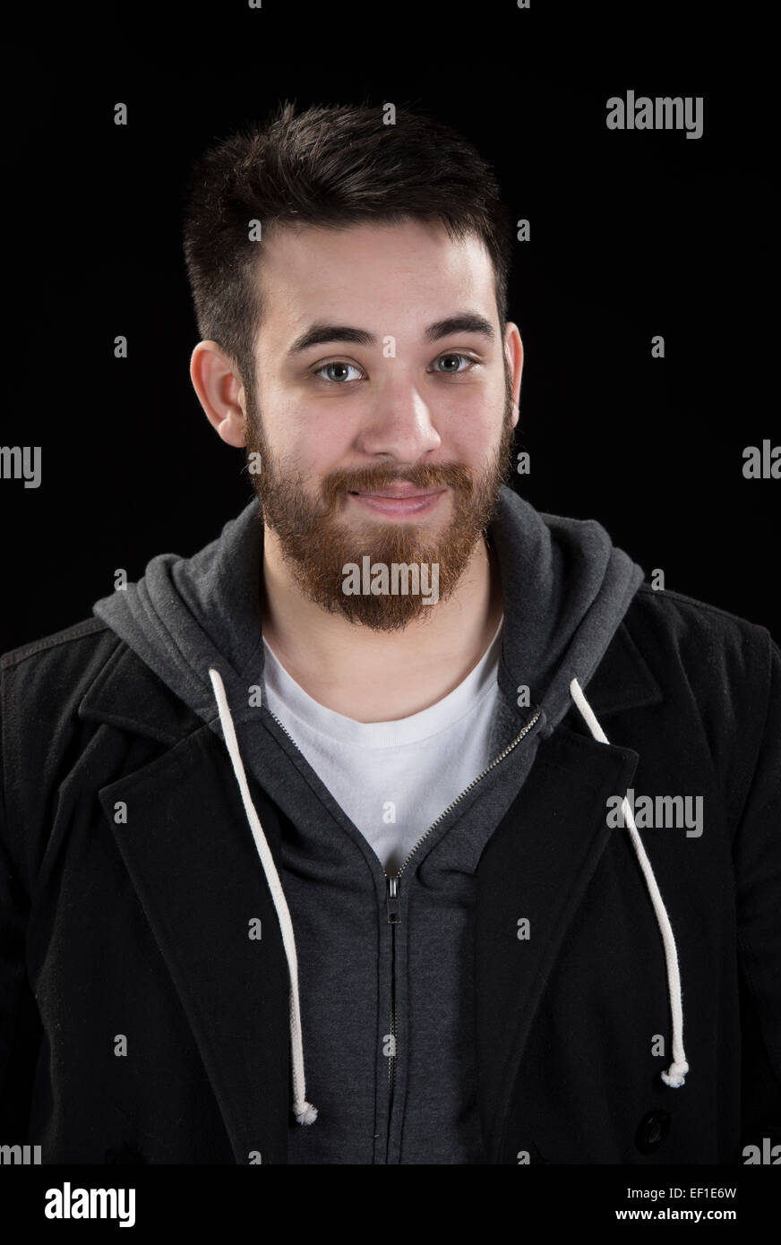 Spitzbart junger Mann in Jacke Blick in die Kamera Stockfoto