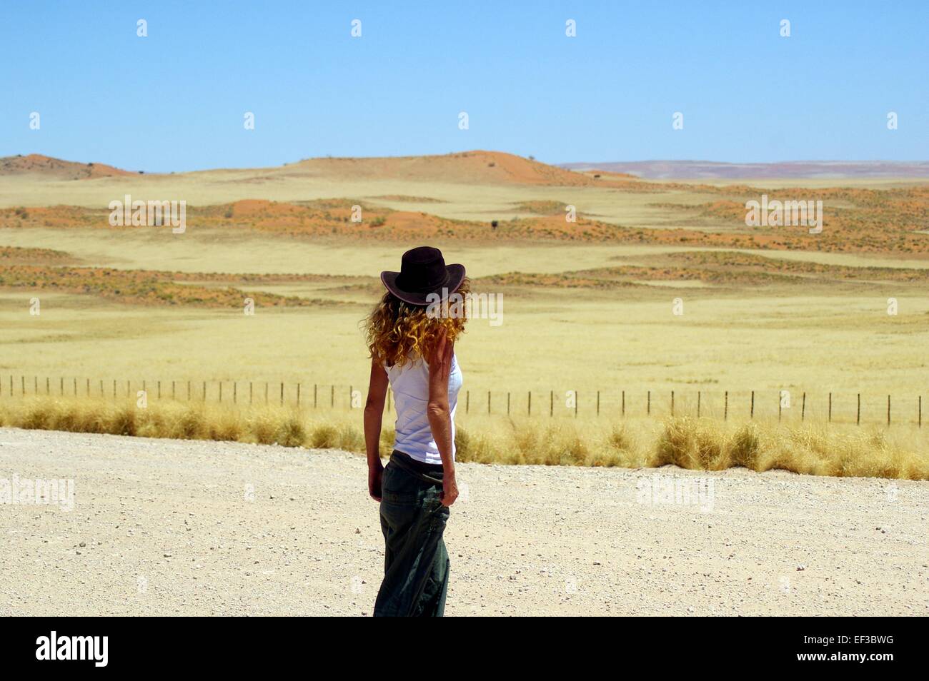 Einsamkeit in Namibia. Frau mit einem Hut Stockfoto