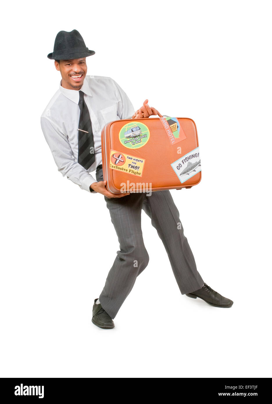 Glücklicher Mann mit einem Koffer Stockfoto
