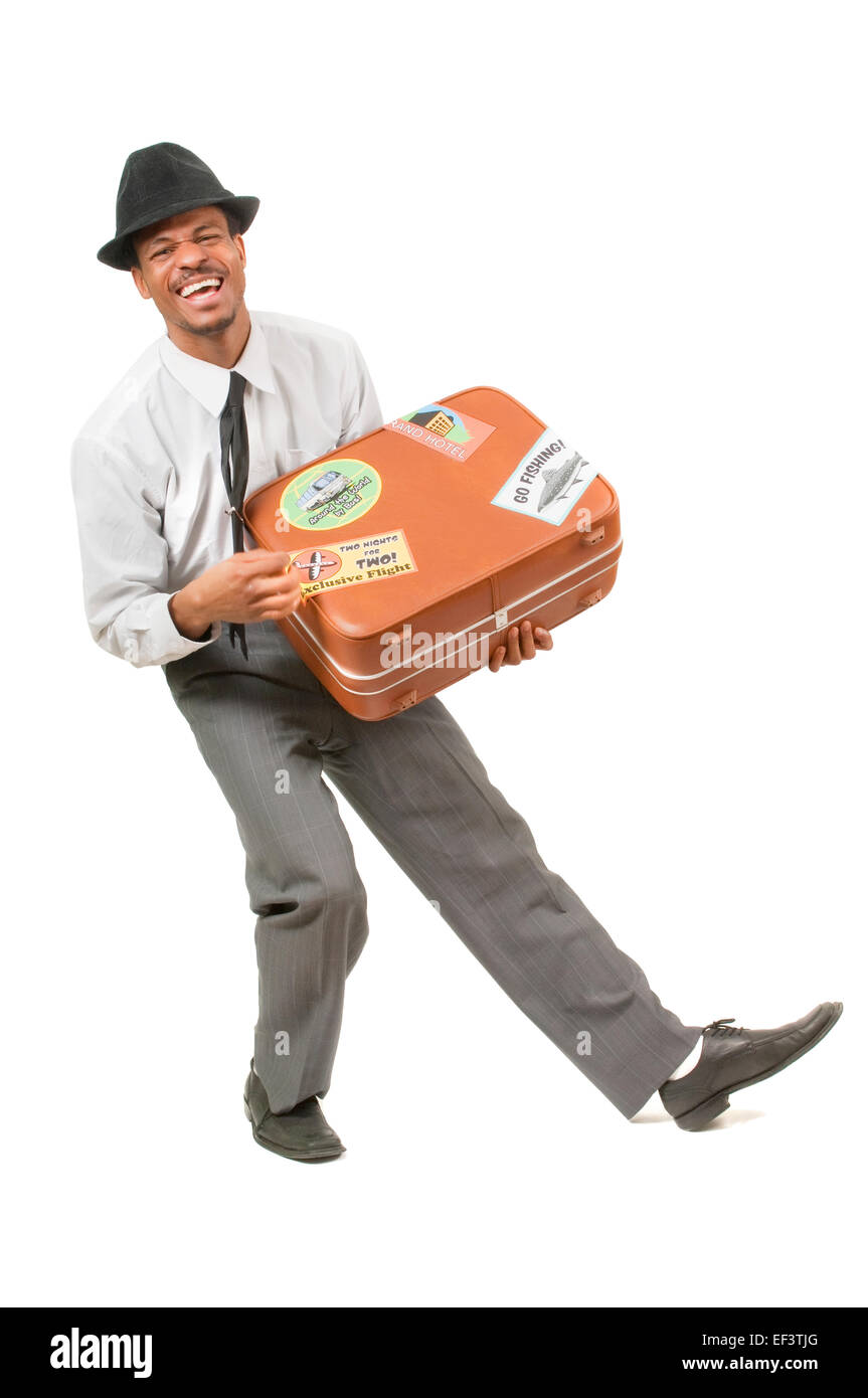 Glücklicher Mann mit einem Koffer Stockfoto