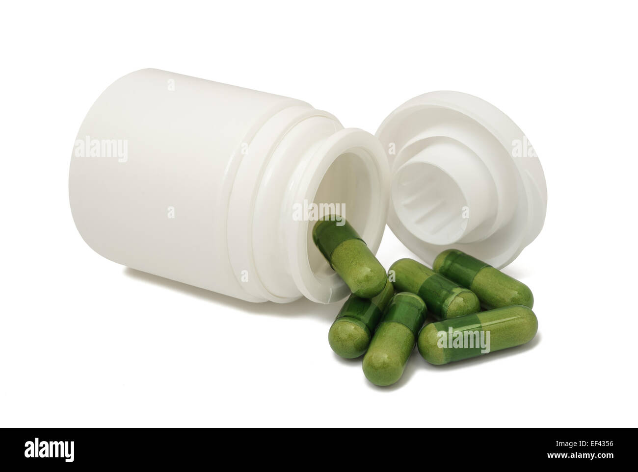 Grüne Pillen mit Container isoliert auf weiss Stockfoto