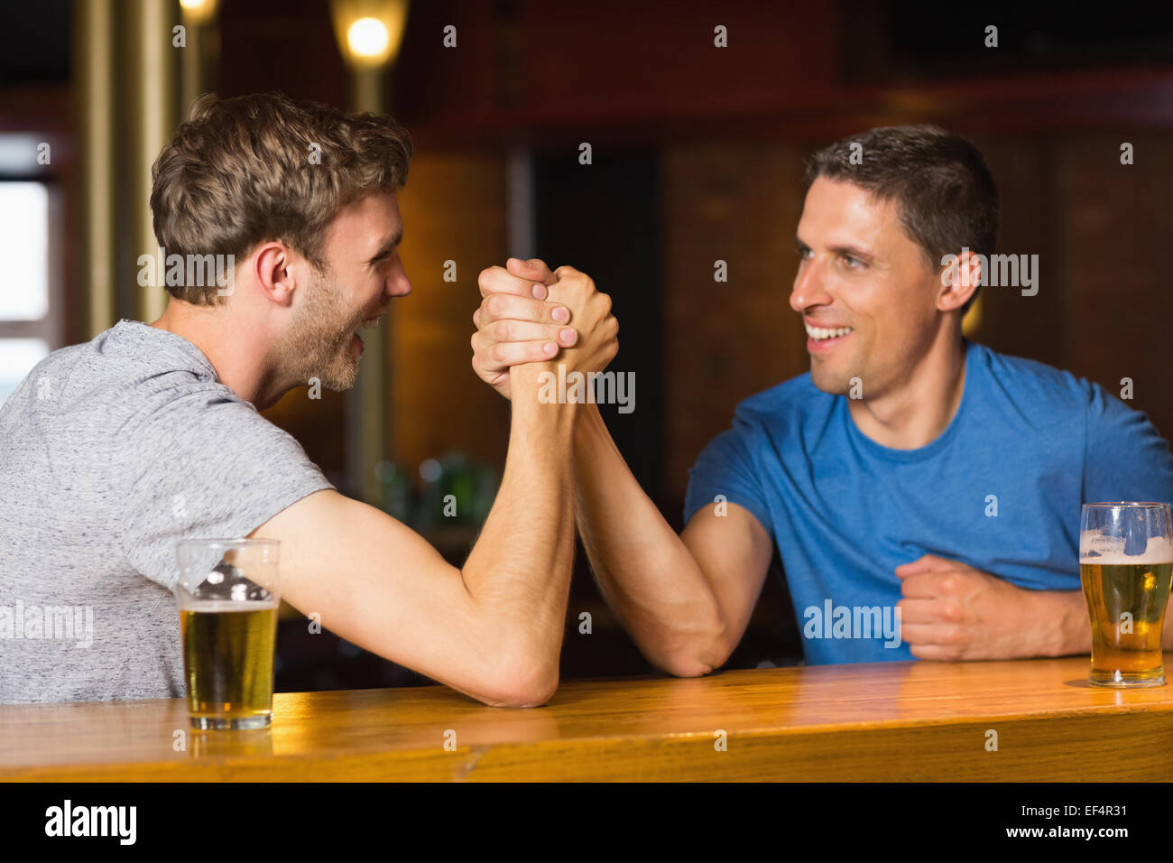 Glücklich Freund Arm wrestling einander Stockfoto