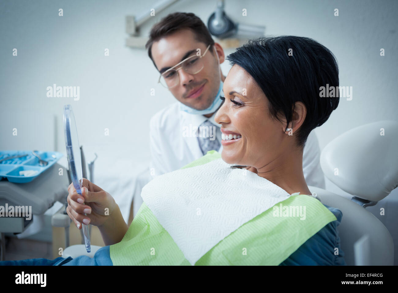 Seitenansicht des lächelnden Patientin mit Zahnarzt Stockfoto