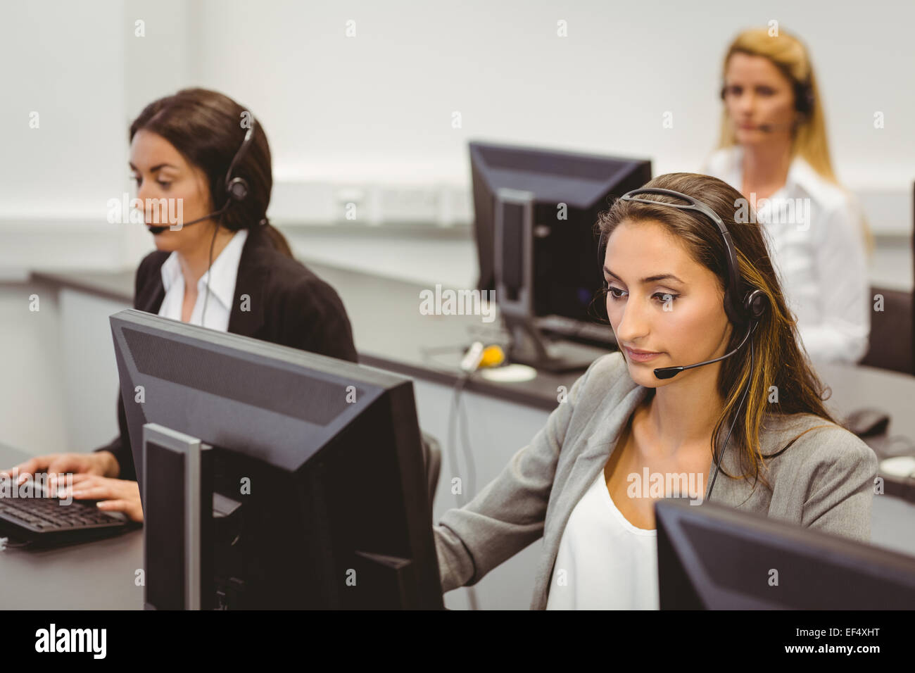 Call Center Agenten sprechen auf die Kopfhörer Stockfoto