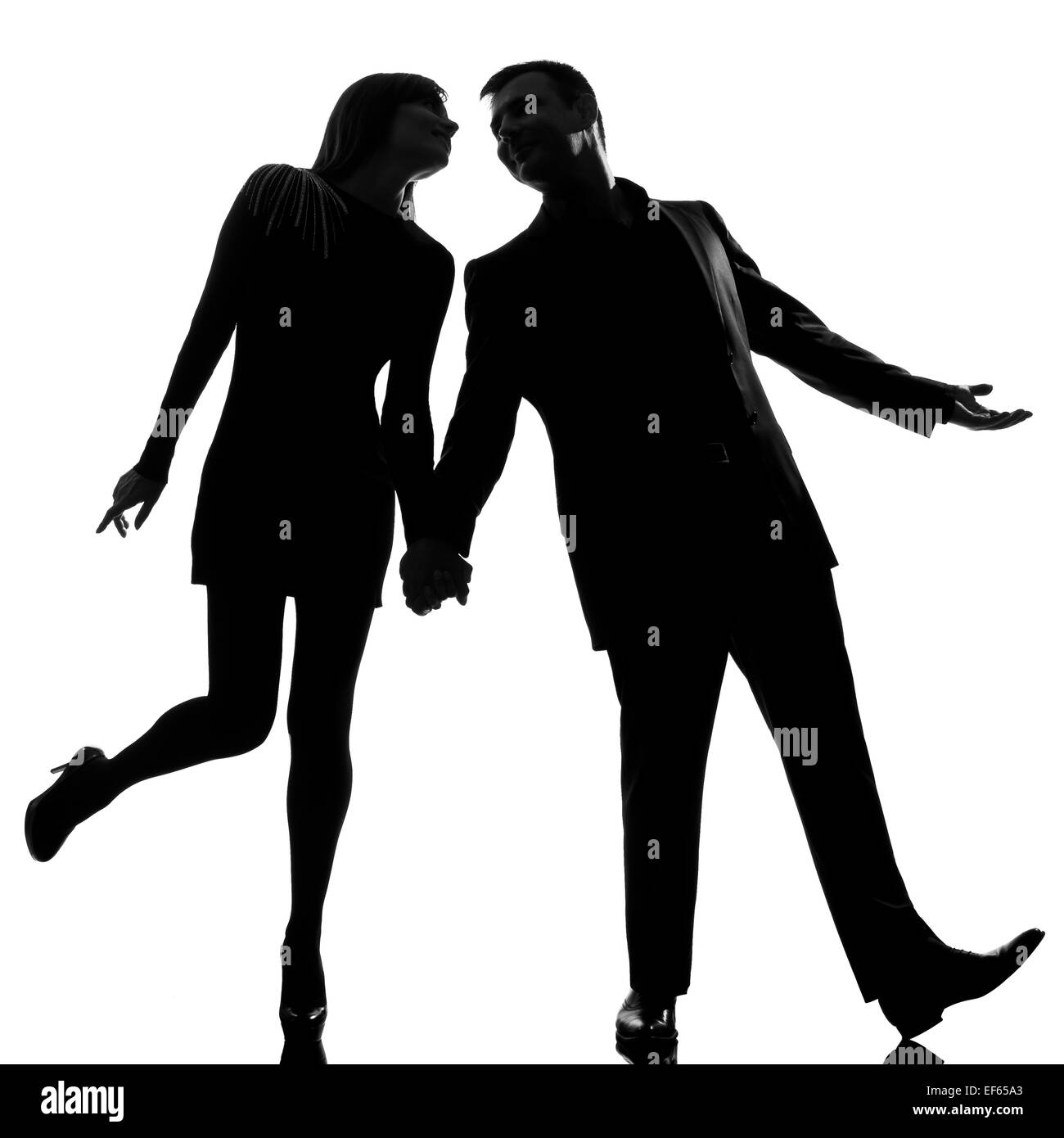 ein Liebhaber kaukasischer paar Mann und Frau gehen hand in Hand Studio Silhouette isoliert auf weißem Hintergrund Stockfoto