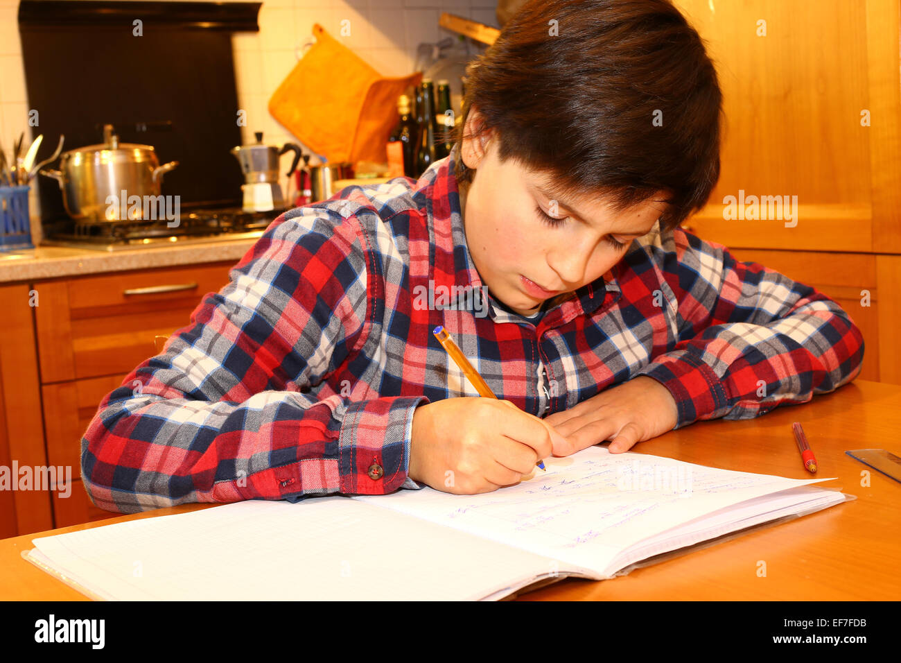 kleiner Junge schreibt auf seinem Notebook zu Hause Stockfoto