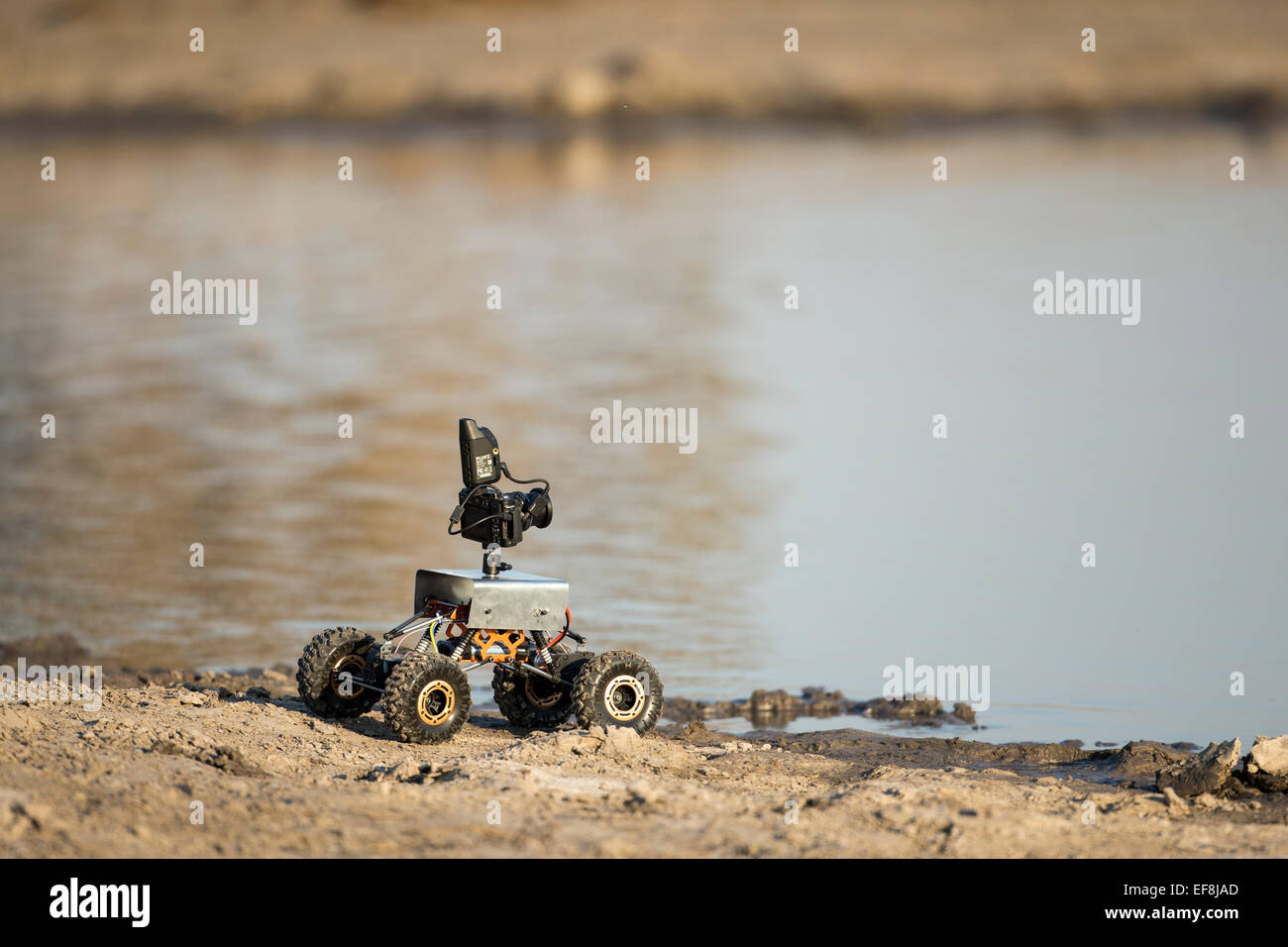 Afrika, Botswana, Chobe National Park, Fernkamera Rover durch Wasserloch in Savuti Marsh positioniert verwendet, um Fotografie Elefant Stockfoto