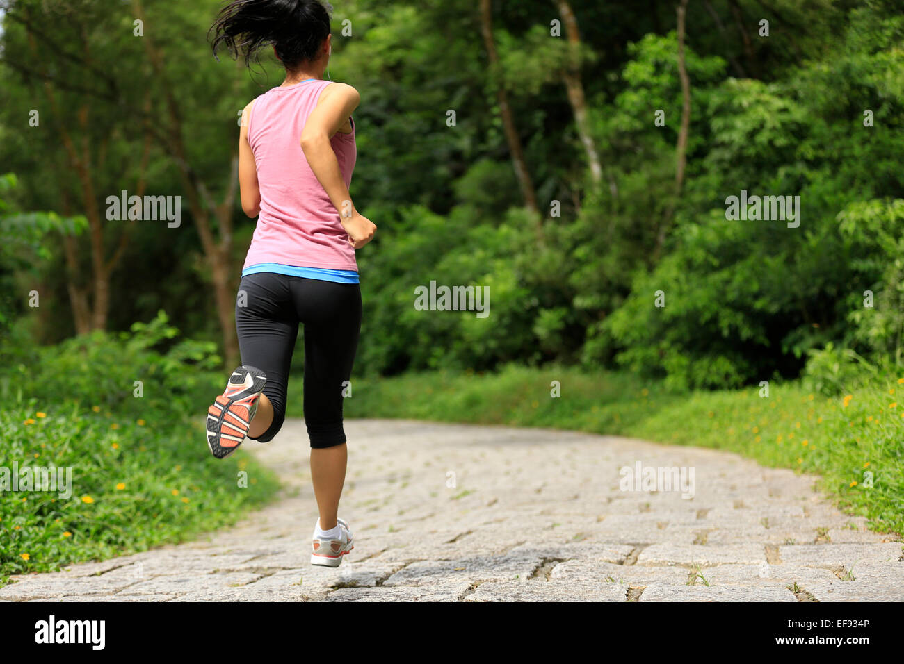 junge Fitness Frau Läufer laufen auf Waldweg Stockfoto