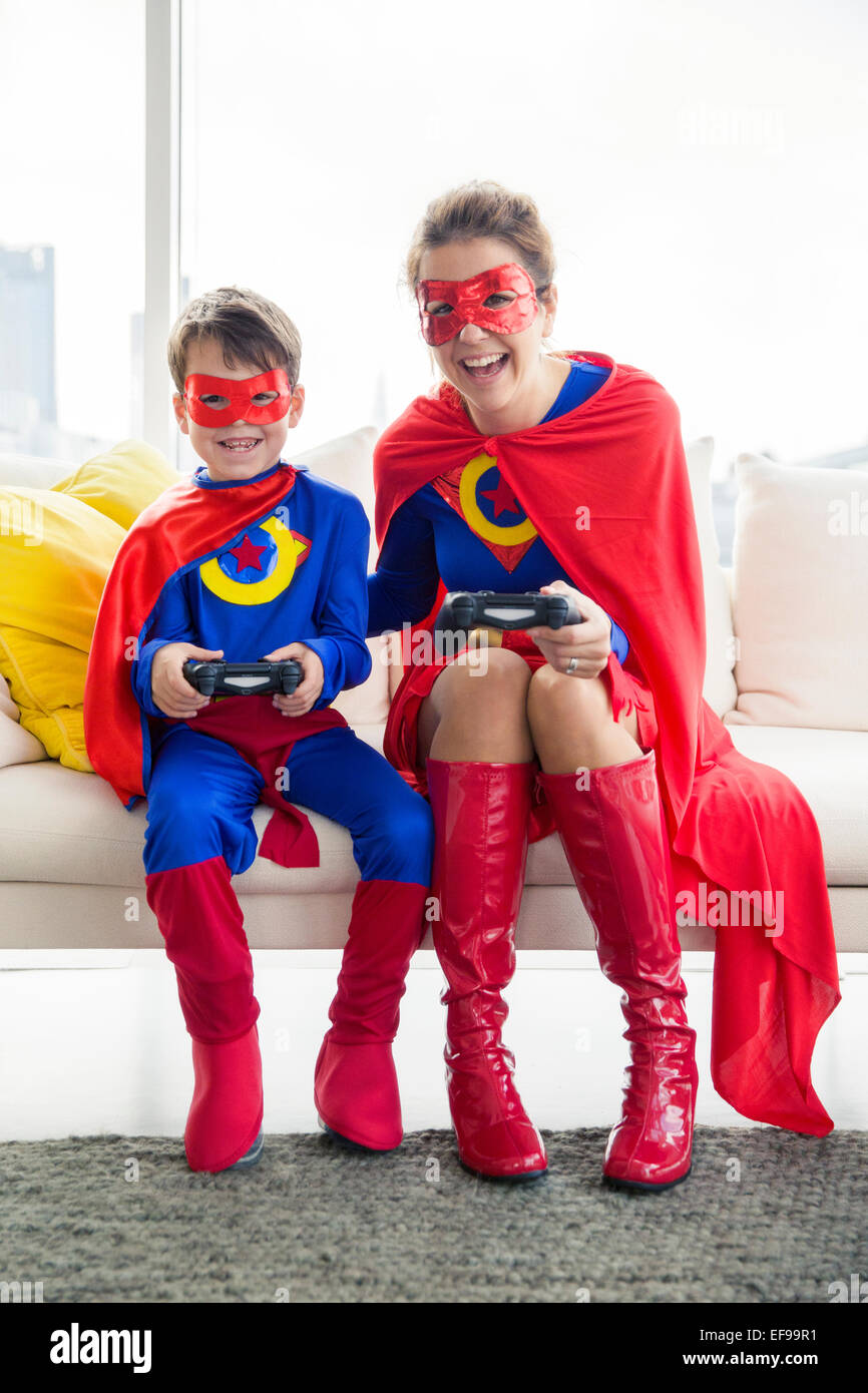 Superhelden-Mutter und Sohn Video Spiel im Wohnzimmer Stockfoto