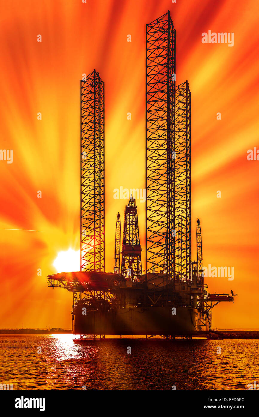 Öl-Bohrinsel im Sonnenuntergang auf dem Meer. Stockfoto