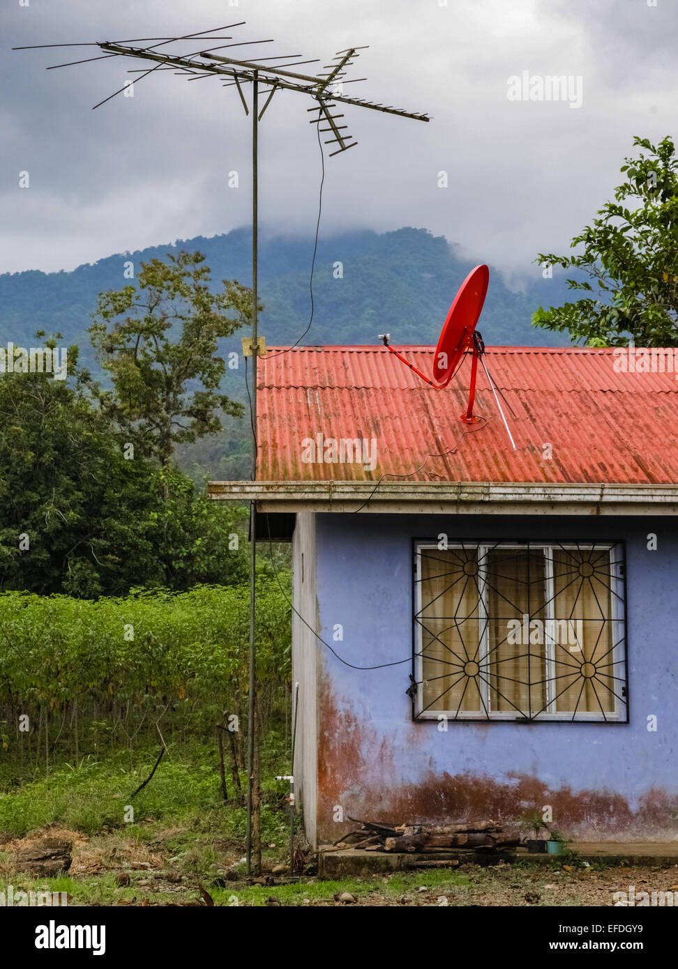 Telekommunikation-Prioritäten der großen Antenne und Satellitenschüssel auf dem Dach eines kleinen Hauses in Costa Rica Stockfoto