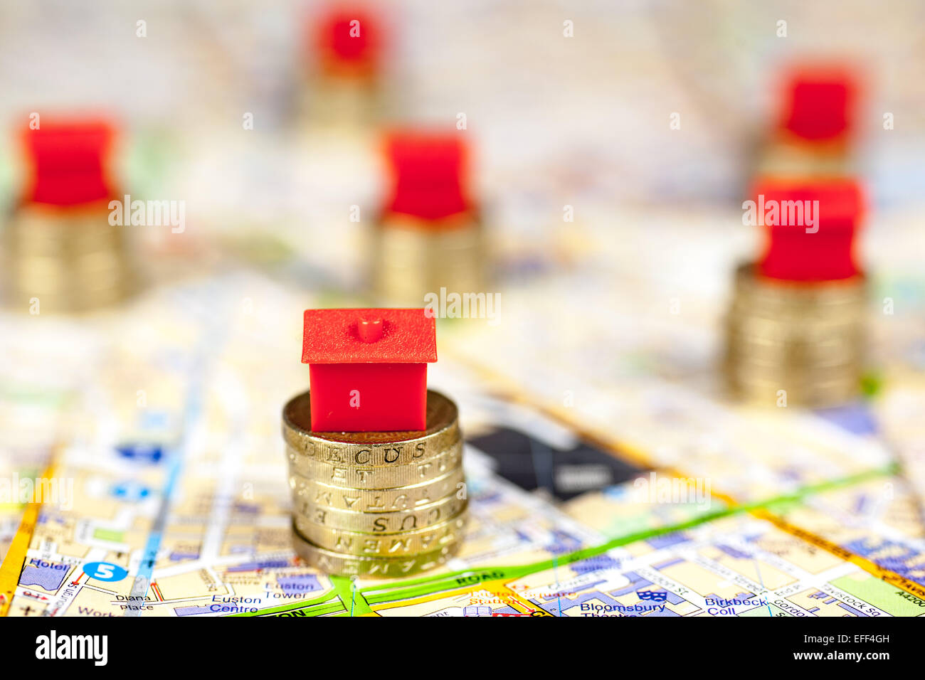 Roten Monopol Häuser auf Pfählen der Pfund-Münzen. Stockfoto