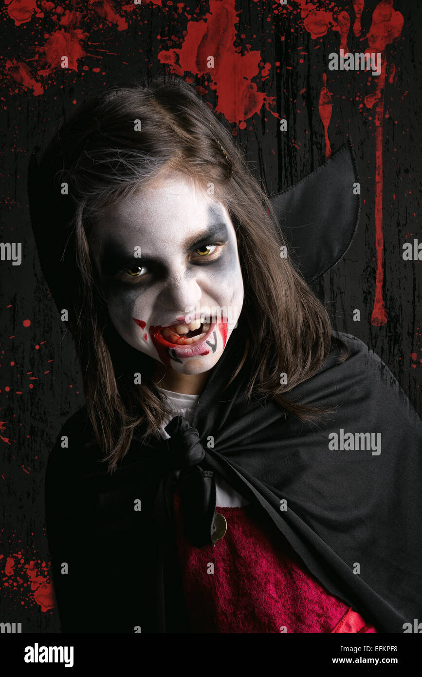 Mädchen mit Gesicht malen und Halloween Vampir Kostüm in einem dunklen  blutigen Hintergrund Stockfotografie - Alamy