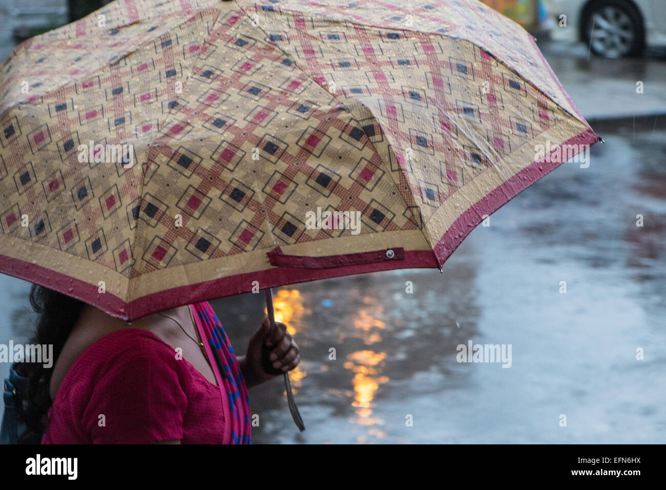 Einheimische mit Regenschirm während starkem Regen Regen während der Regenzeit vor Hauptbahnhof station Colombo, Sri Lanka, Asien Stockfoto