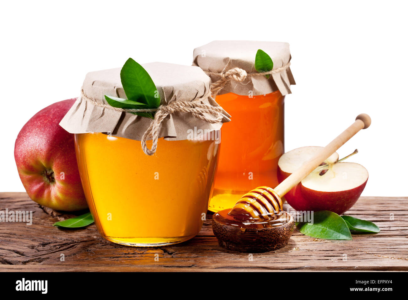 Glas-Dosen voller Honig und Äpfel auf Holz. Beschneidungspfade. Stockfoto
