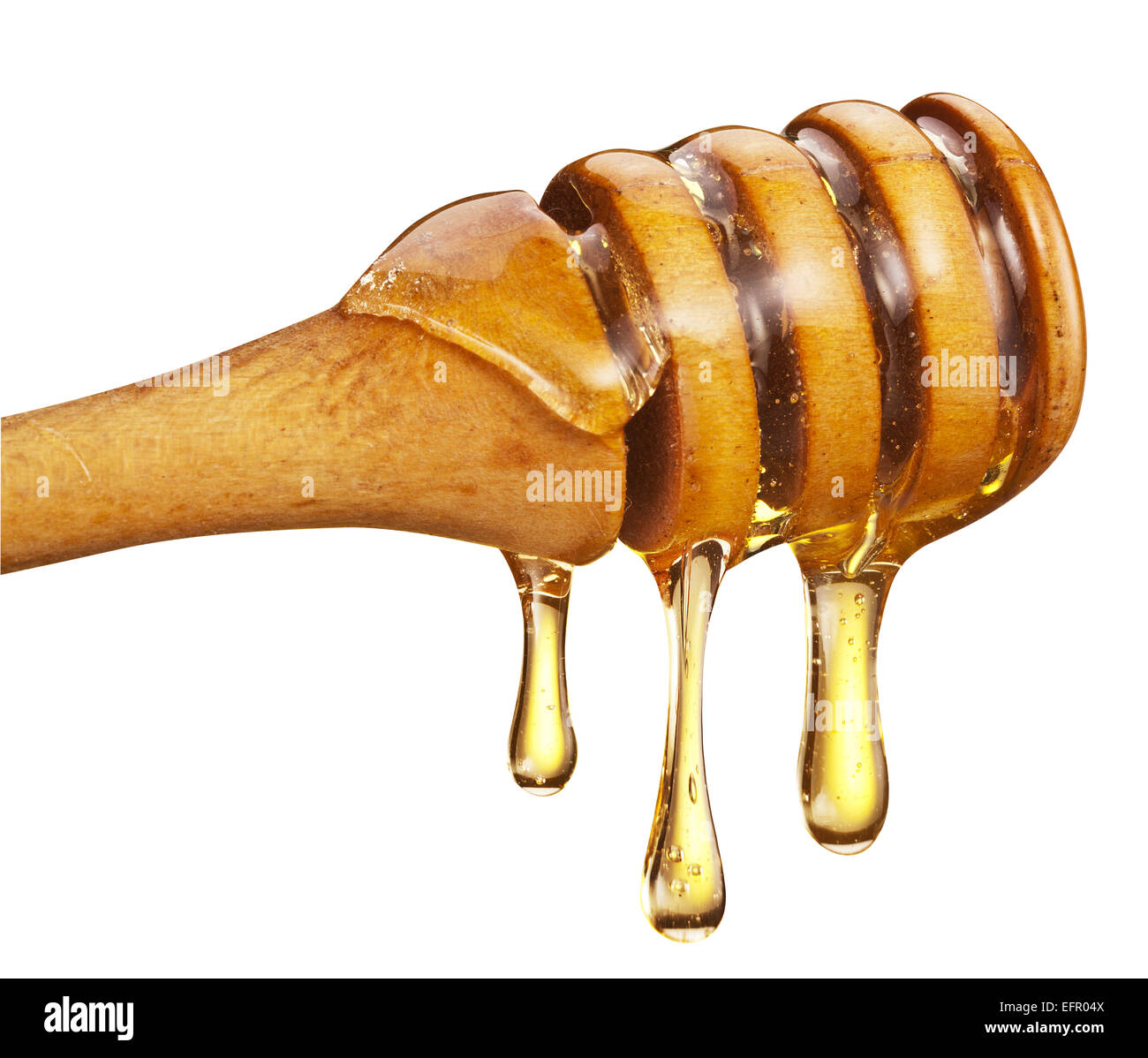 Honig-Tröpfchen aus Holzstab auf weißem Hintergrund. Beschneidungspfade. Stockfoto
