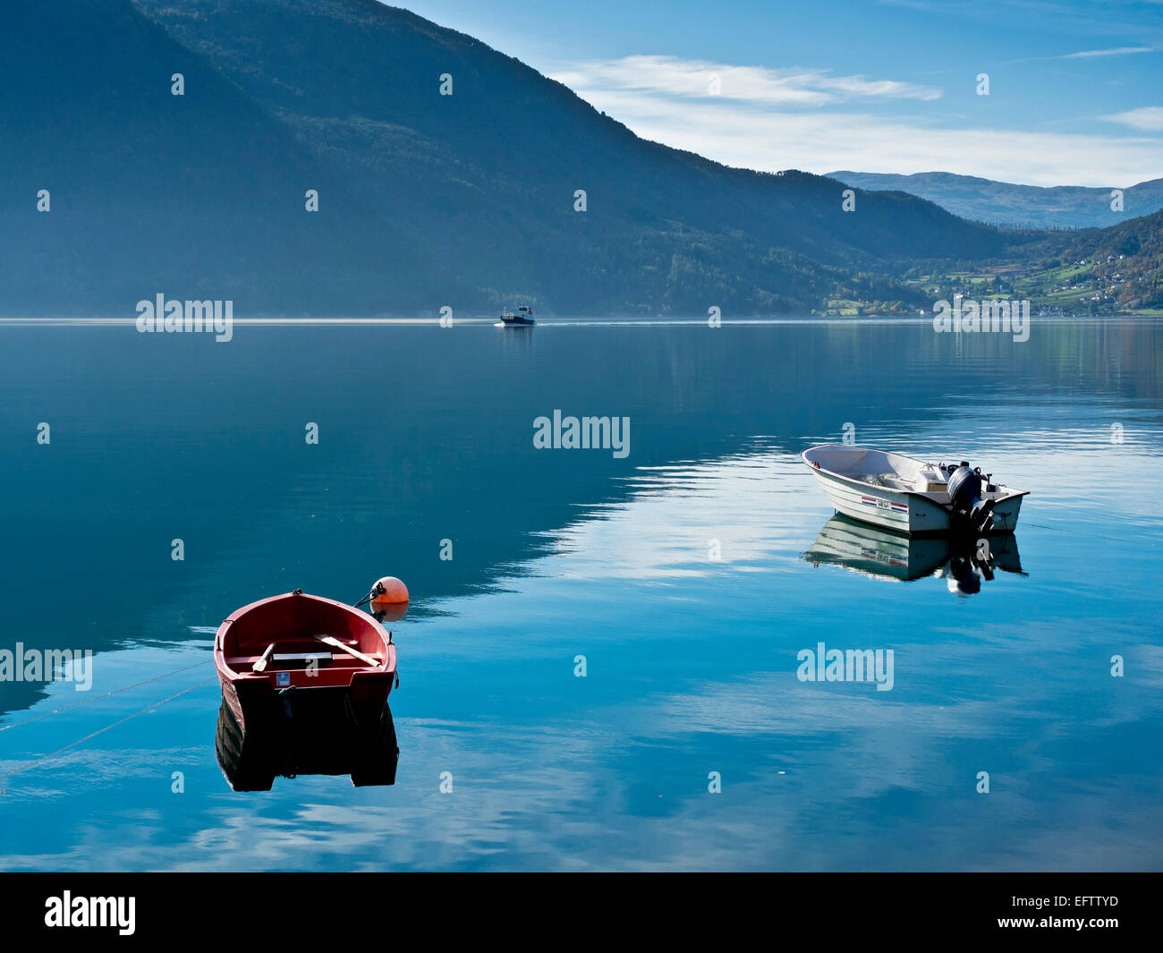 Fähre Solvorn, Urnes, die älteste norwegische Stabkirche, überqueren den Fjord, kleinen Motorbooten vor, ruhige See, Spiegelung Stockfoto