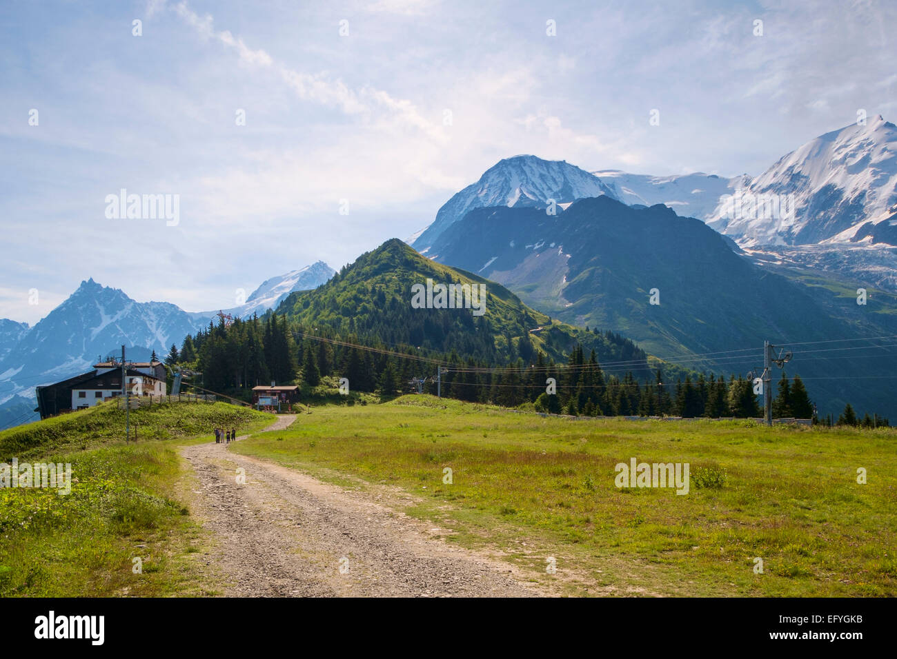 Spaziergang auf einem Bergpfad über dem Chamonix-Tal in Richtung der Seilbahnstation Bellevue mit Mont Blanc hinter (R), Chamonix, Frankreich, Europa Stockfoto
