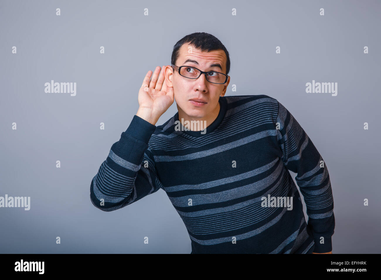 Männchen der Europäischen Erscheinungsbild Brunet legte seine Hand auf sein Ohr auf gr Stockfoto