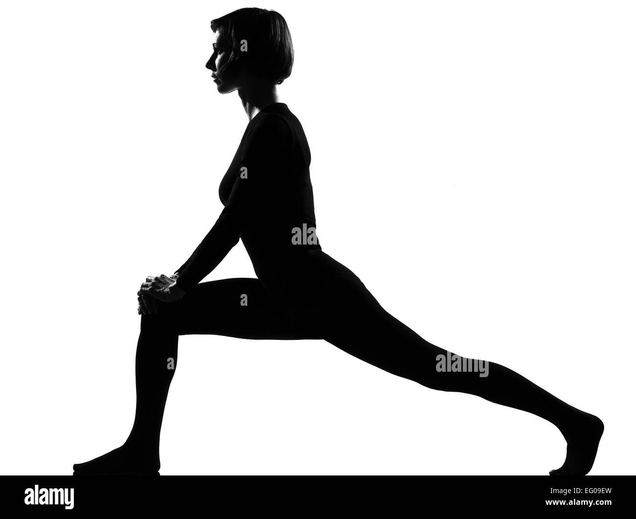 Frau Sport Fitness Workout Yoga Beine Aufwärmen im Schatten Graustufen Silhouette voller Länge im Studio isoliert weißen Hintergrund Stockfoto