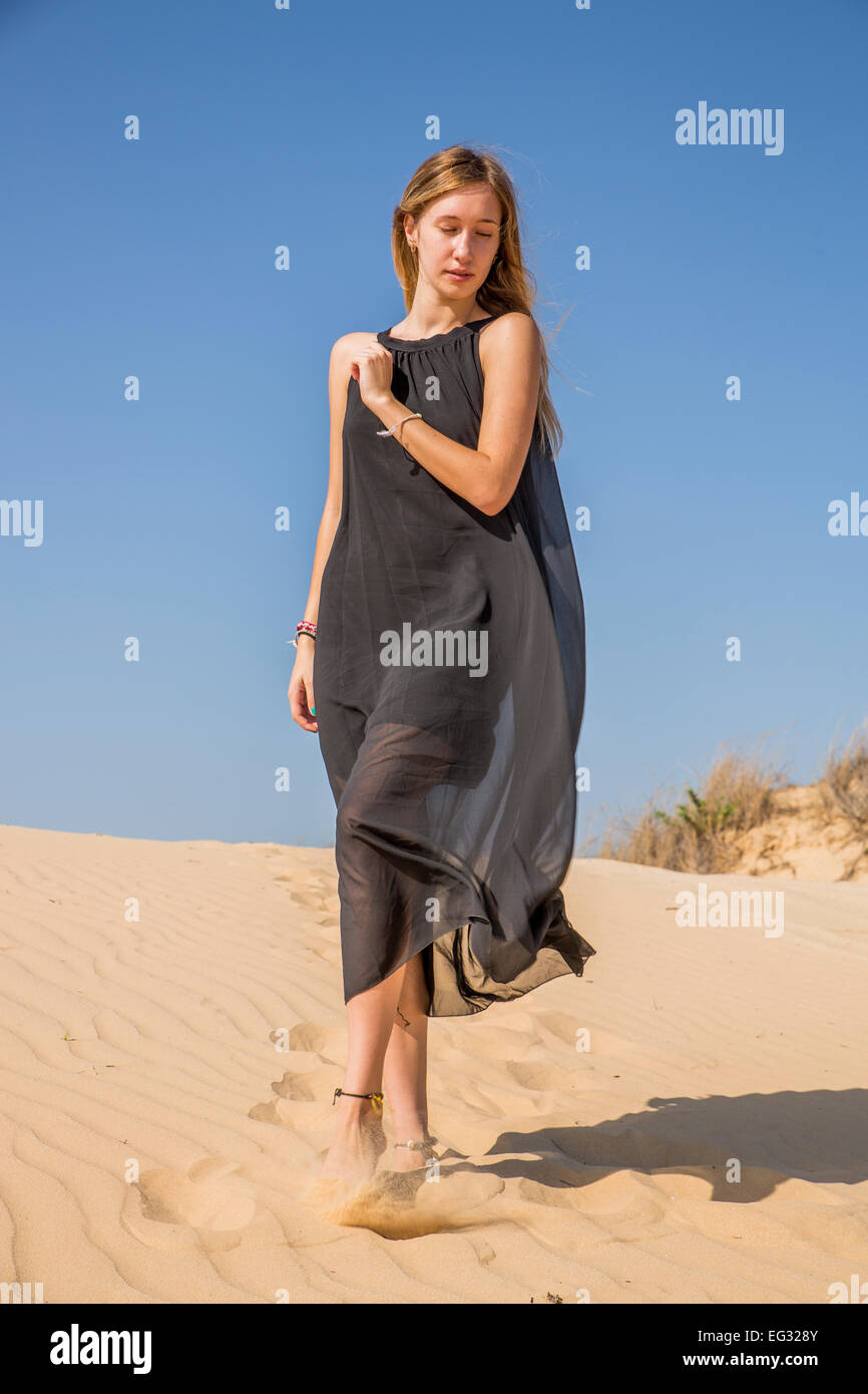 Frau im langen schwarzen Kleid am Strand Modell veröffentlicht Stockfoto