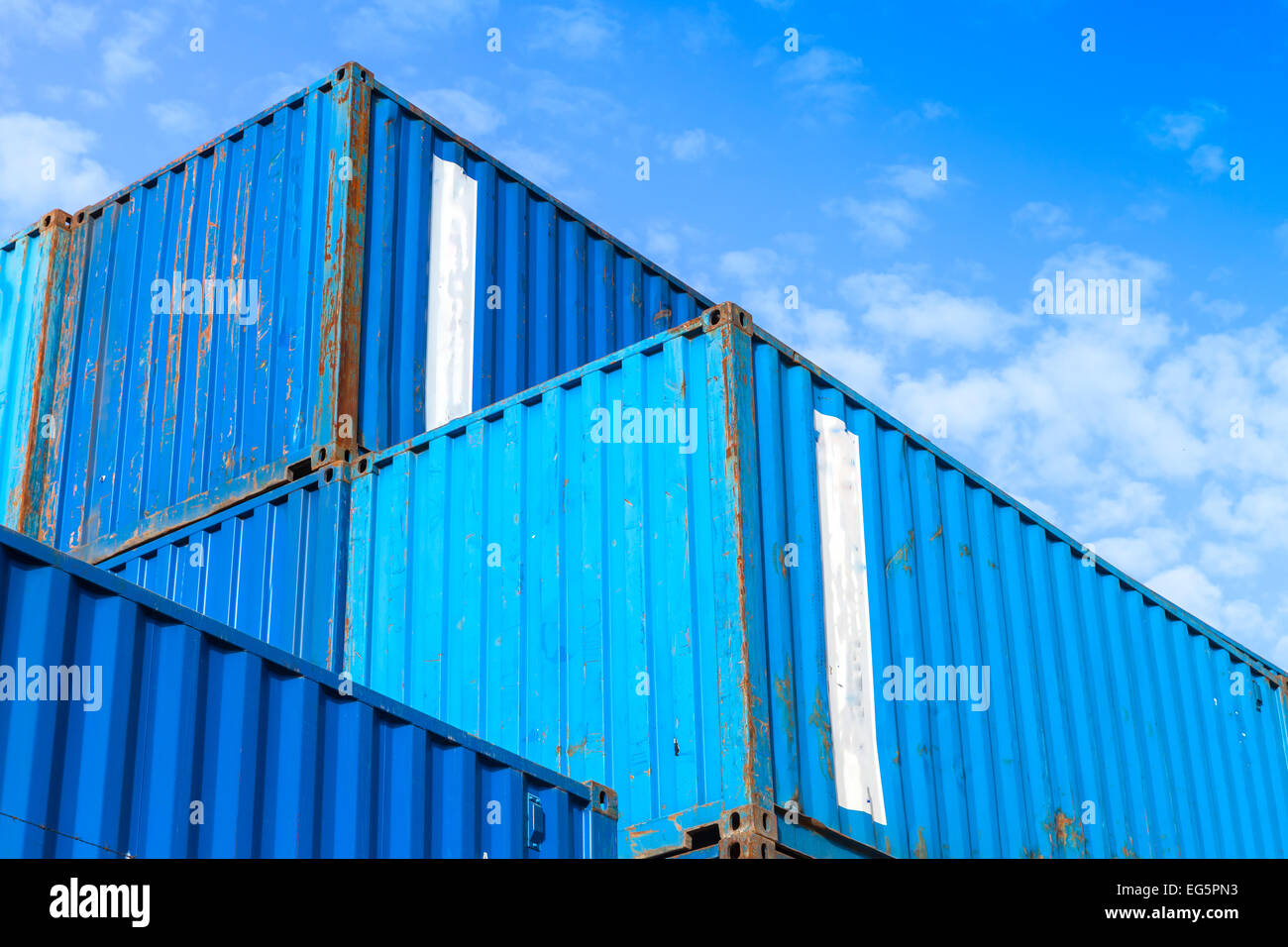 Blau Metall Industrie Ladungsbehälter gestapelt in den Lagerraum unter blauen Wolkenhimmel Stockfoto