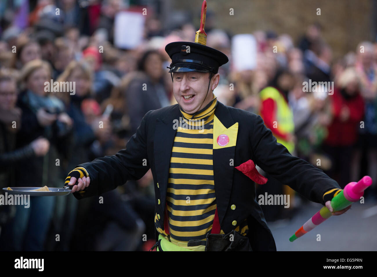 Die große Spitalfields Pancake Race 2015. Die jährliche Veranstaltung findet am Faschingsdienstag Geldbeschaffung für die London Air Ambulance basiert auf The Royal London Hospital in Whitechapel, London. Stockfoto