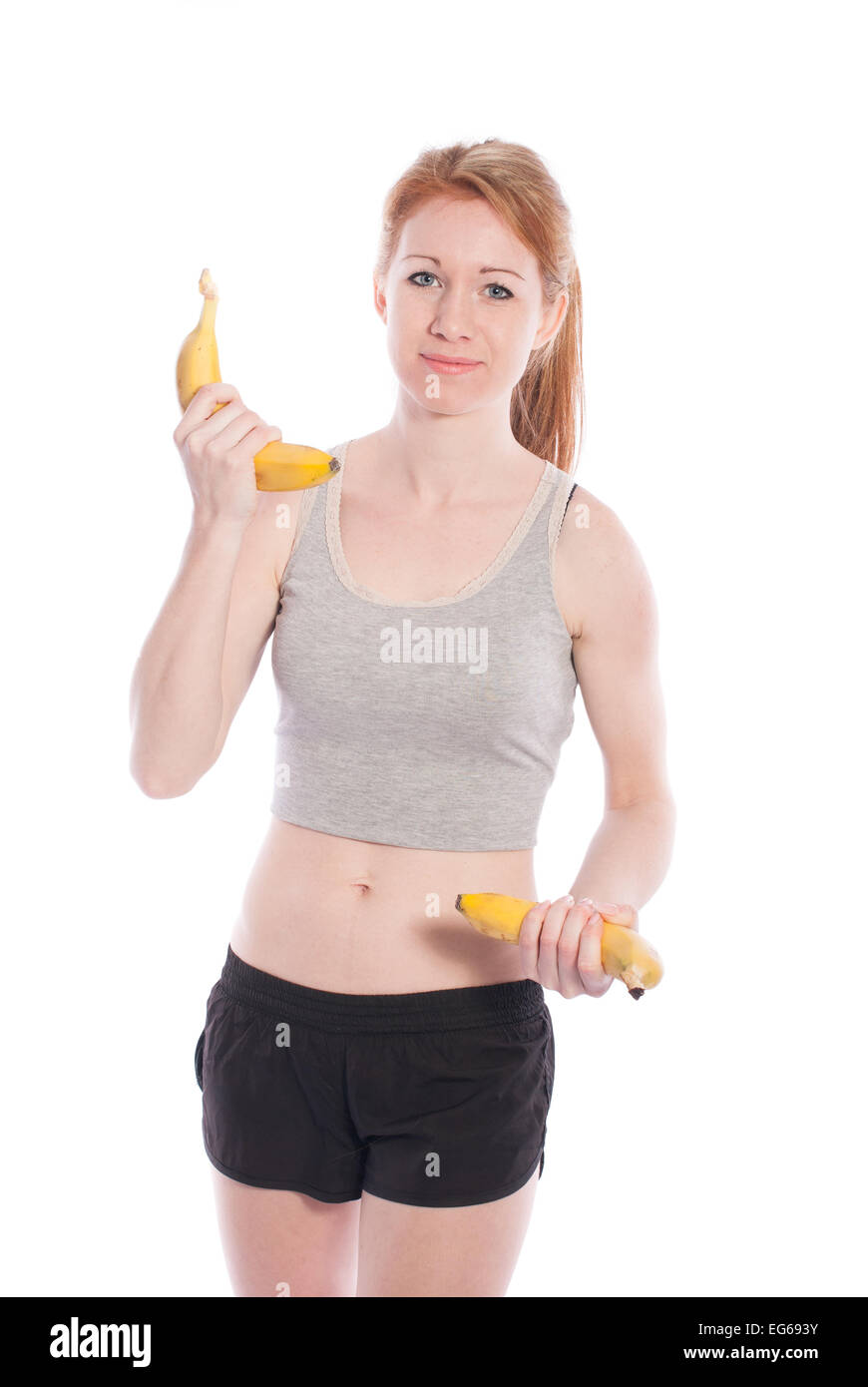 Sportliche Mädchen mit Bananen in der Hand auf weißem Hintergrund. Stockfoto