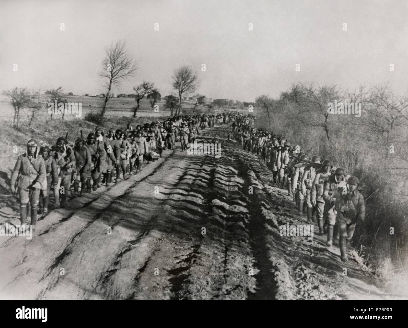 Chinesischer Bürgerkrieg 1946-1949. Soldaten der chinesischen nationalistischen Armee marschieren entlang eine unebene Straße in der Mandschurei. 29. Januar 1947. - Stockfoto