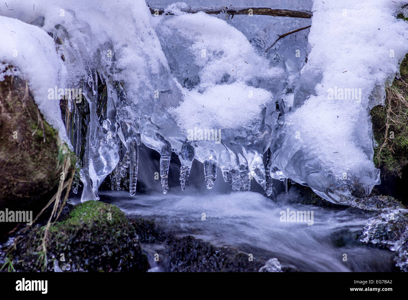 Eiszapfen und Schnee im fließenden Wasser Stockfoto