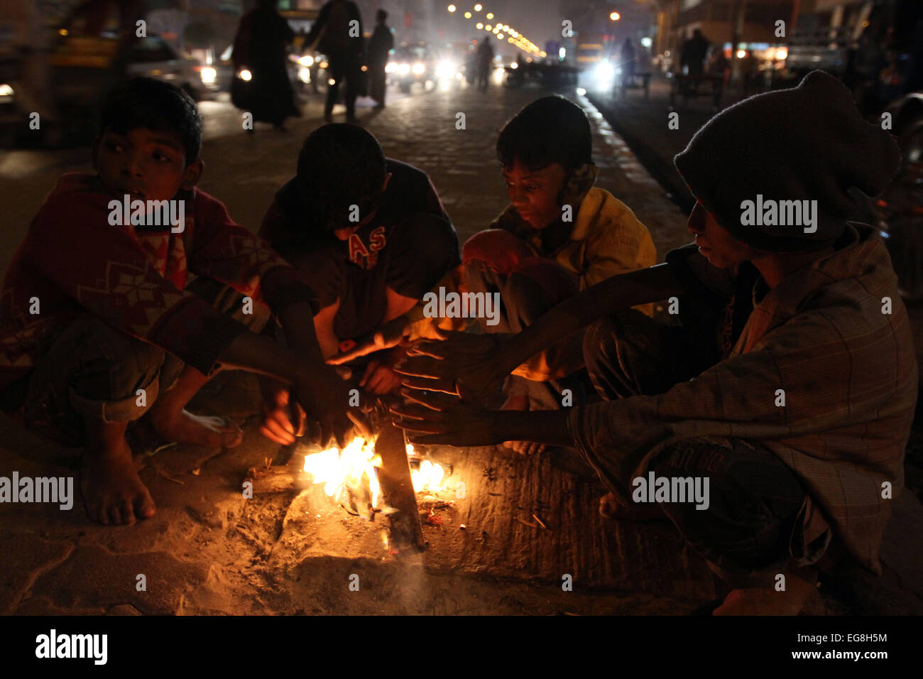 Obdachlose Kinder erstellen Feuer, indem sie verworfen, Holz oder Kunststoff etwas Wärme zu geben, Temperaturen im Winter d Stockfoto