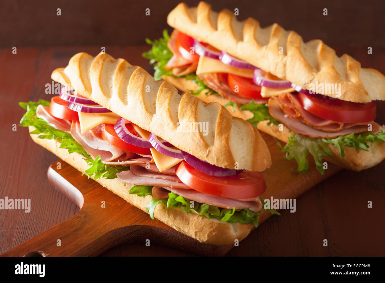 langes Baguette-Sandwich mit Schinken-Käse-Tomaten und Salat Stockfoto