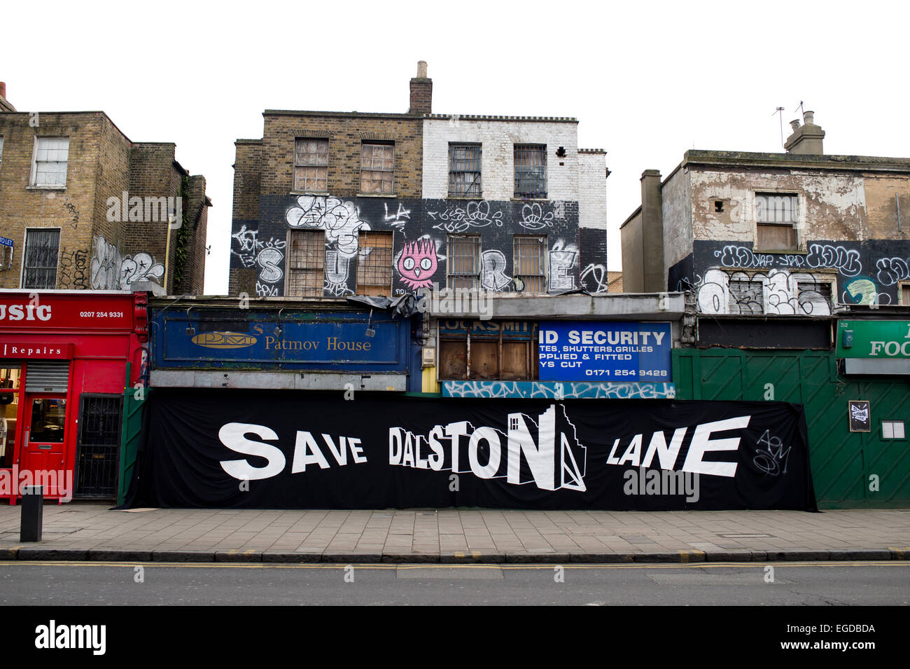 Hackney. Dalston Lane. Abgebrochene Geschäfte vor der Sanierung. Großes Schild mit der Aufschrift "Speichern Dalston Lane". Stockfoto
