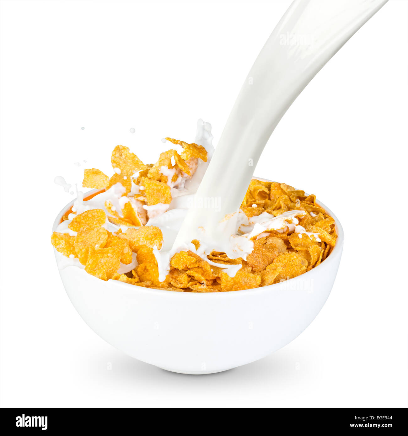 Milch spritzt in Schüssel Cornflakes Stockfotografie