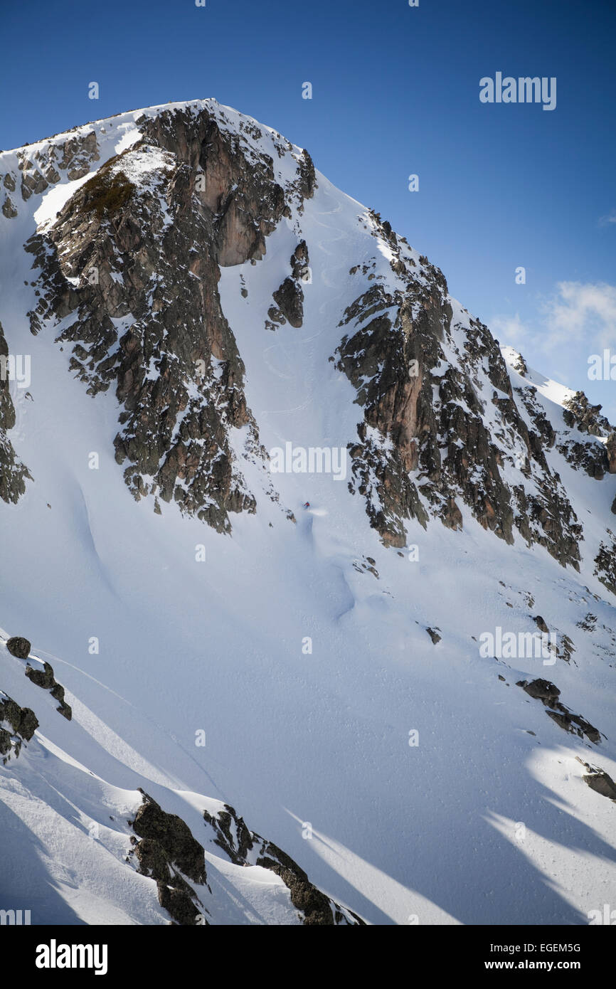 Freeride-Skifahrer in einem steilen Couloir absteigen. Stockfoto